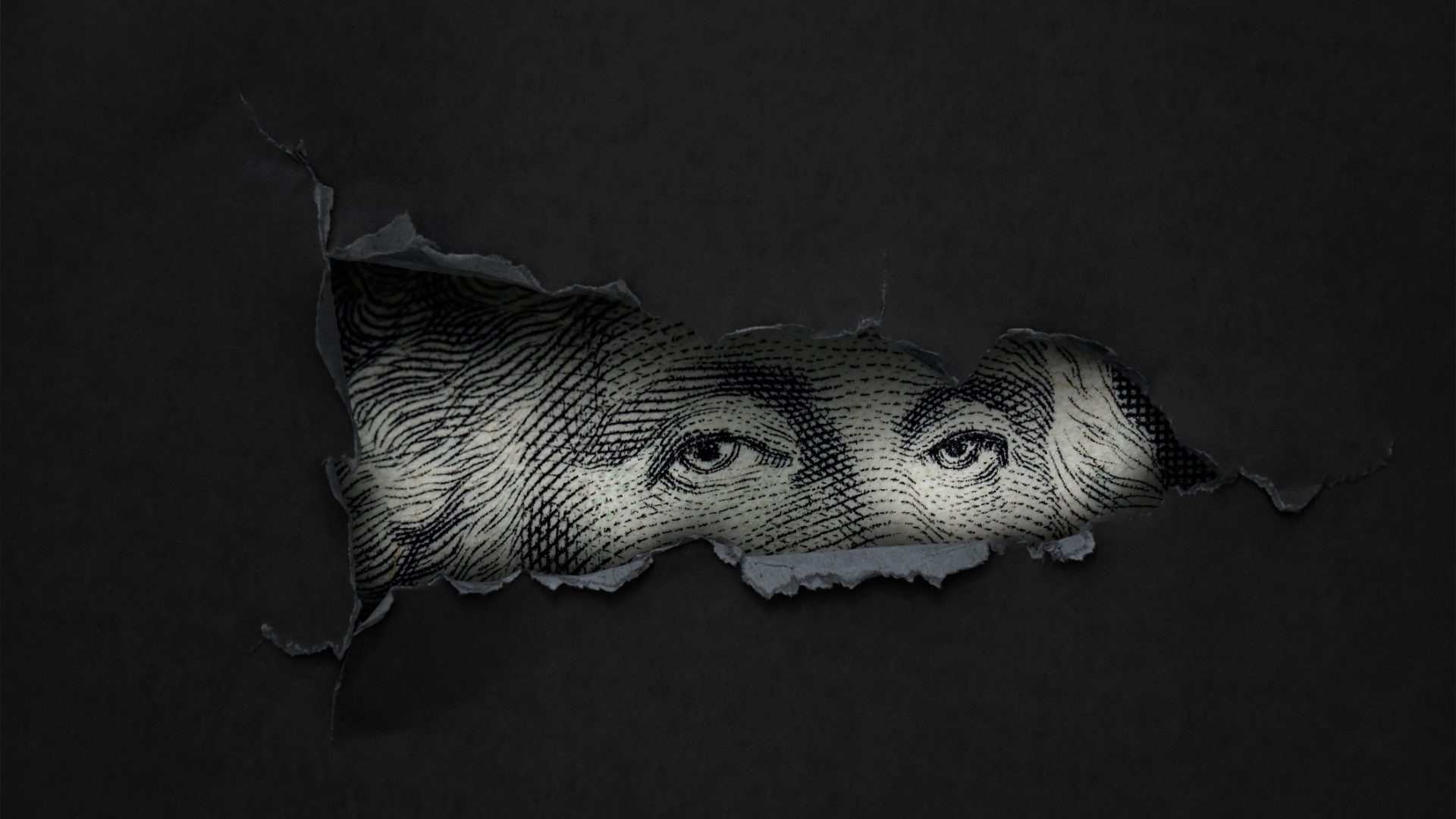 black screen with hole where eyes of George Washington from US bill show through